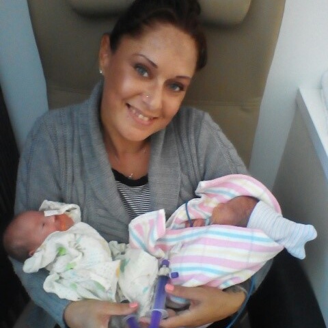 Mother holding twin daughters